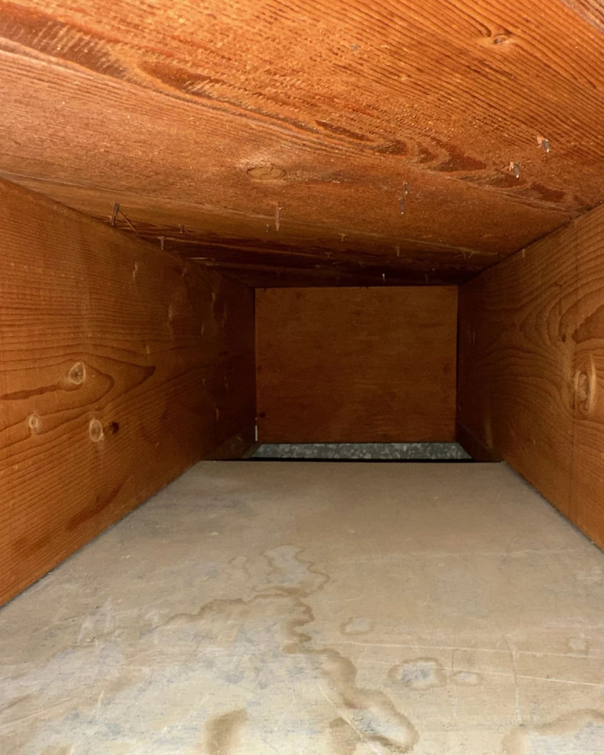 The same duct trunk cleaned down to bare wood after professional duct cleaning